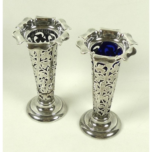 720 - A pair of silver posy vases, each decorated with scrolling design of shamrocks, and with flared six ... 