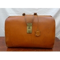 A vintage tan leather Gladstone bag with brass fittings.