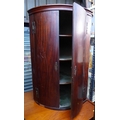 A late 19th century barrel fronted corner cabinet.