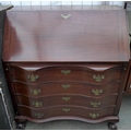 A mid 20th century mahogany serpentine fronted bureau, fall front, four drawers, claw and ball feet.