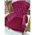 A modern button back armchair, in Victorian spoon back style, with purple velour upholstery.
