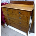 An Edwardian mahogany chest of drawers, two over three graduating drawers.