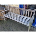 A modern two seater garden bench, with slatted back and seat.