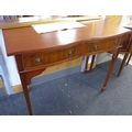 A reproduction mahogany veneered side table, with double serpentine fronted outline, two frieze draw... 