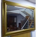 A modern gilt framed wall mirror, with rectangular bevelled plate and moulded frame.