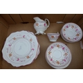 A Sutherland lustre part tea service, the bodies decorated with pink lustre bands flanking floral de... 