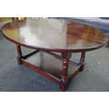 An oval hardwood coffee table.