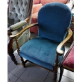 A mid 20th century low open armchair, upholstered in petrol blue cotton.