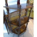 A Victorian style three tier whatnot, with inlaid decoration and spiral twist columns.