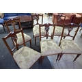 A set of six Edwardian mahogany dining chairs, with carved frames, upholstered in cream foliate fabr... 