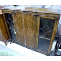 An Edwardian mahogany display cabinet, with shaped front outline, burr walnut veneered, and cabriole... 