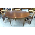 A 1970's extending dining table with a central folding leaf and three chairs. (4)