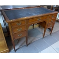 A Victorian desk, circa 1880, with seven drawers, brass handles and inset top.