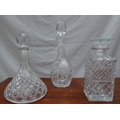 Three cut glass decanters, largest 32cm high. (3)