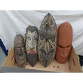 A selection of four African carved wooden masks, one early to mid 20th century, the others later. (1... 
