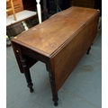 A Victorian mahogany drop leaf table with turned supports, 40.5 (117 with leaves up) by 105 by 69.5c... 