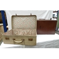 Two early to mid 20th century vintage suitcases comprising a small case covered in cream faux lizard... 