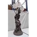 A 20th century bronzed resin figural lamp, modelled as a girl holding two doves with three lights ab... 