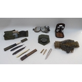 A group of militaria including a pair of flying goggles, a sash made from spent machine gun belt and... 