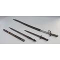 Two bayonets and a North African sword, comprising a St Etienne WWI bayonet, a further later bayonet... 