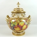 A modern Royal Worcester twin handled ‘bow’ vase and cover, with applied twin handles, swags and pie... 