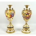 A pair of modern Royal Worcester pedestal vases, foliate clasped twin handles, decorated in a 'Hand ... 