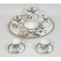 A Victorian Royal Worcester porcelain tete a tete tea service, decorated in Chinese style with prunu... 