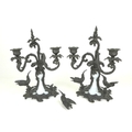 A pair of bronze and milk glass twin branch candlesticks, possibly French 19th century, each with sc... 