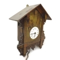 A 19th century cuckoo wall clock, painted case with two figures, with two weights, and pendulum. 32.... 