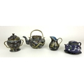 A Chinese Cloisonne bachelor's tea set, comprising teapot, sugar bowl and milk jug, the black ground... 