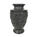 A late 19th / early 20th century black stone vase, carved with a dragon chasing the flaming pearl, l... 