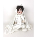 An early 20th century German bisque headed doll, marked Germany to back of neck, clothed in vintage ... 