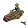 A Schuco Curvo 1000 Motorcycle and rider, Brevete France S.G.D.G. and key, 12.5 by 4.5 by 9.5cm. (2)