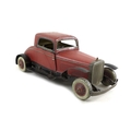 A Burnett Ltd London clockwork tin plate saloon car, in red and black, with tin plate tyres, 25.5cm ... 