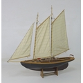 A scratch built model yacht with double masts and gaff rigging, mid 20th century, with black hull, b... 