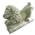 A carved stone garden ornament modelled as a lion, mid to late 20th century, with bared fangs and a ... 