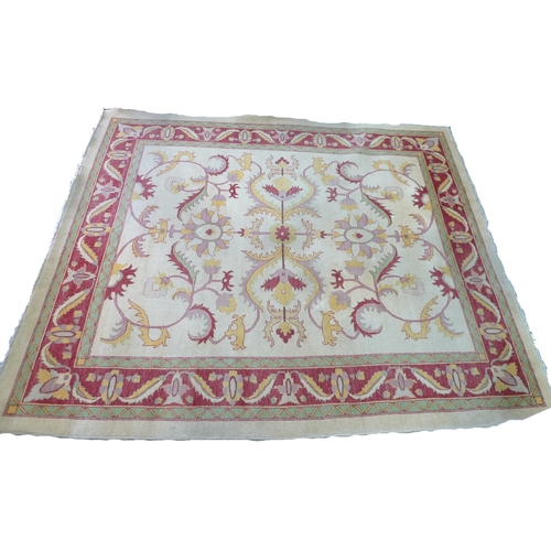 204 - A Turkish large wool rug, with cream ground, scrolling floral decoration in yellow, red and pink, 33... 