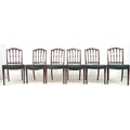 A set of six Sheraton style mahogany dining chairs, carved splats to an arched top rail, dark green ... 