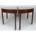 A pair of George III cuban flame mahogany demi-lune pier tables, raised on square section reeded leg... 