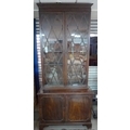 An early 19th century mahogany bookcase, with unusually tall astragal diamond paned glazed doors enc... 