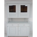 A French white painted oak dresser, with glazed doors enclosing a single shelf above, and two drawer... 