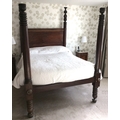 A 19th century four poster bed with ring turned supports, approximately 201 by 150 by 230cm high ove... 