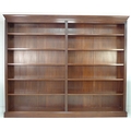 A large modern reproduction two division bookcase, in the Georgian style, mahogany veneered, with te... 