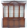 A modern reproduction display bookcase in the Georgian style, mahogany veneered, with pierced swan n... 
