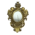 A small Italian 18th / 19th century giltwood wall mirror, with small oval plate, the frame carved wi... 