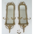 A pair of 19th century and later gilt framed girandole mirrors, with moulded fruit and leaf frames a... 