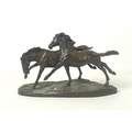 A Heredities bronzed resin sculpture of two stallions running wild, on a naturalistic oval base, num... 