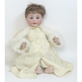 A Jutta baby doll, circa 1922, with sleeping eyes, open mouth, and a swans down hood, 55cm.