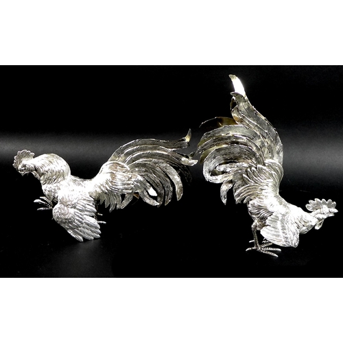 1 - A pair of silver fighting cockerels, each cast with feathered detailing, London import mark, 1957, J... 