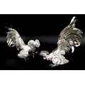 A pair of silver fighting cockerels, each cast with feathered detailing, London import mark, 1957, J... 